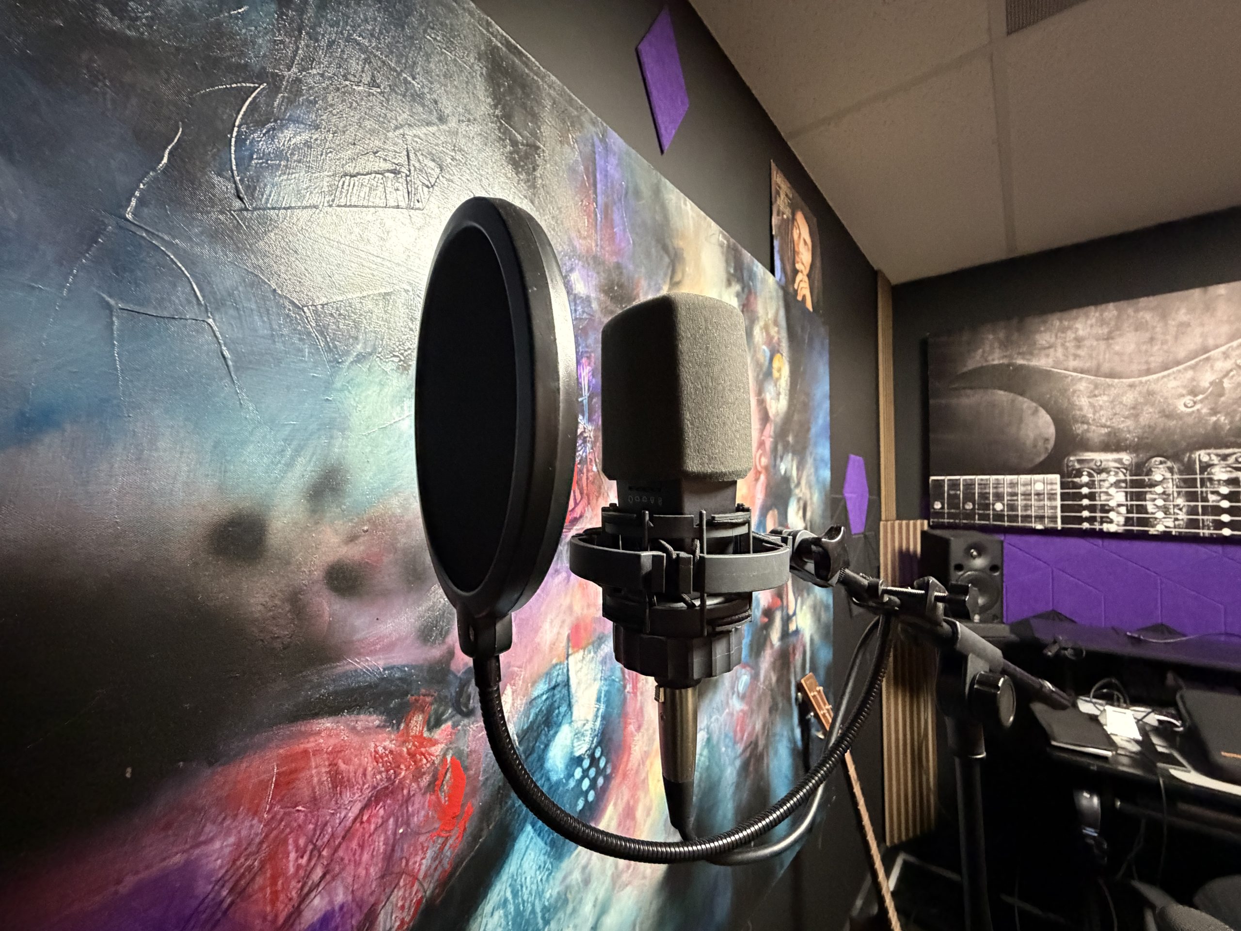 Condenser microphone with a pop filter set up for vocal recording in the music room