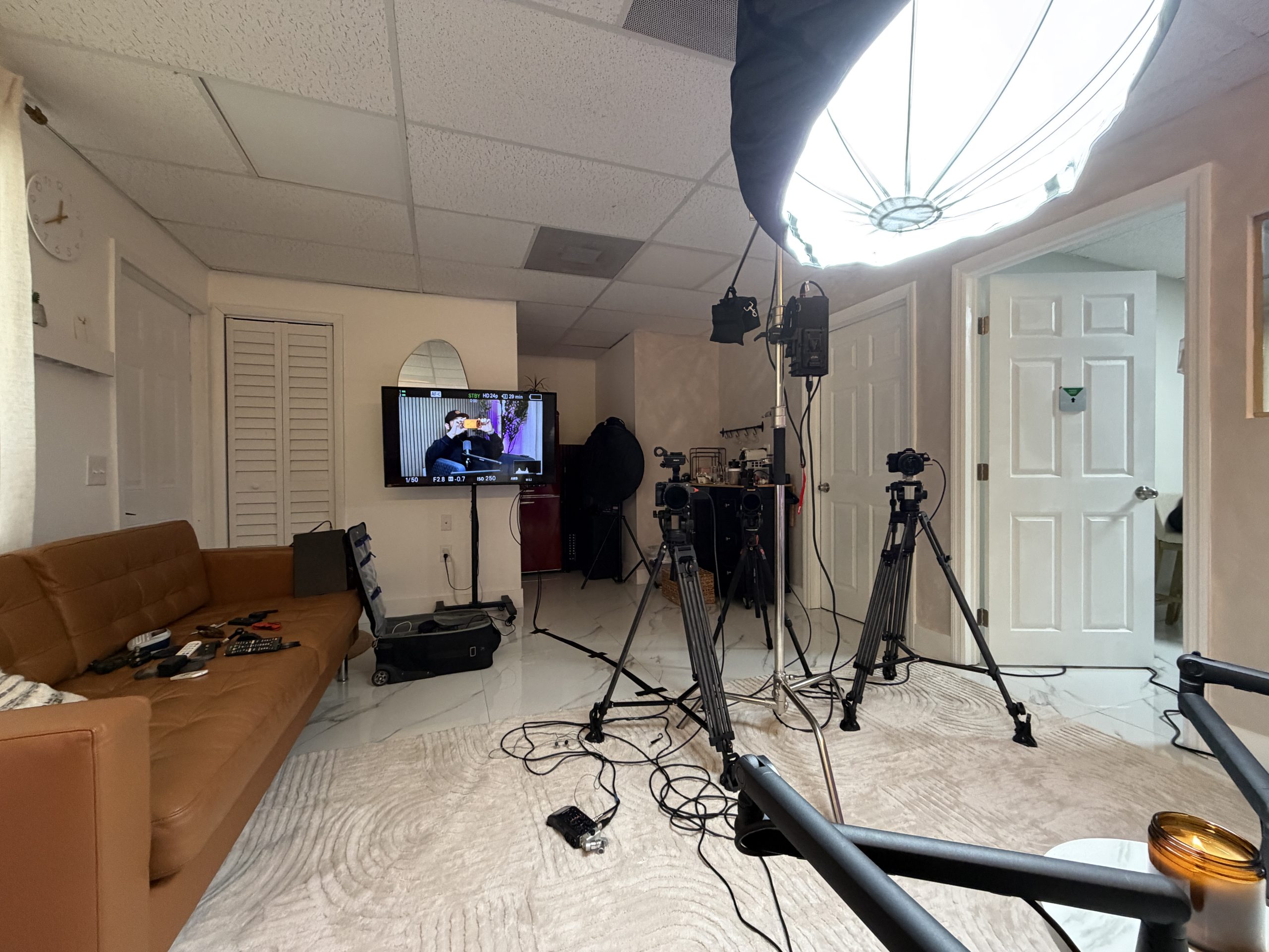 Wide view of the studio with softbox lighting, monitor and camera equipment set up for a shoot