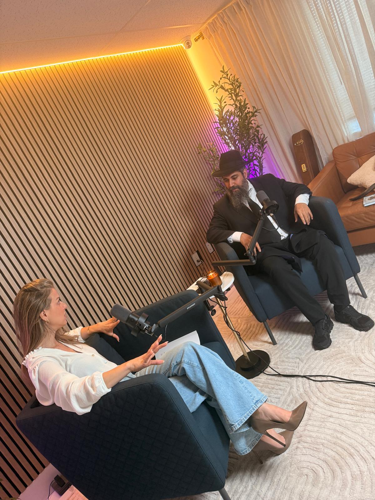 Two people seated in armchairs during a recorded podcast conversation at Spark Studio