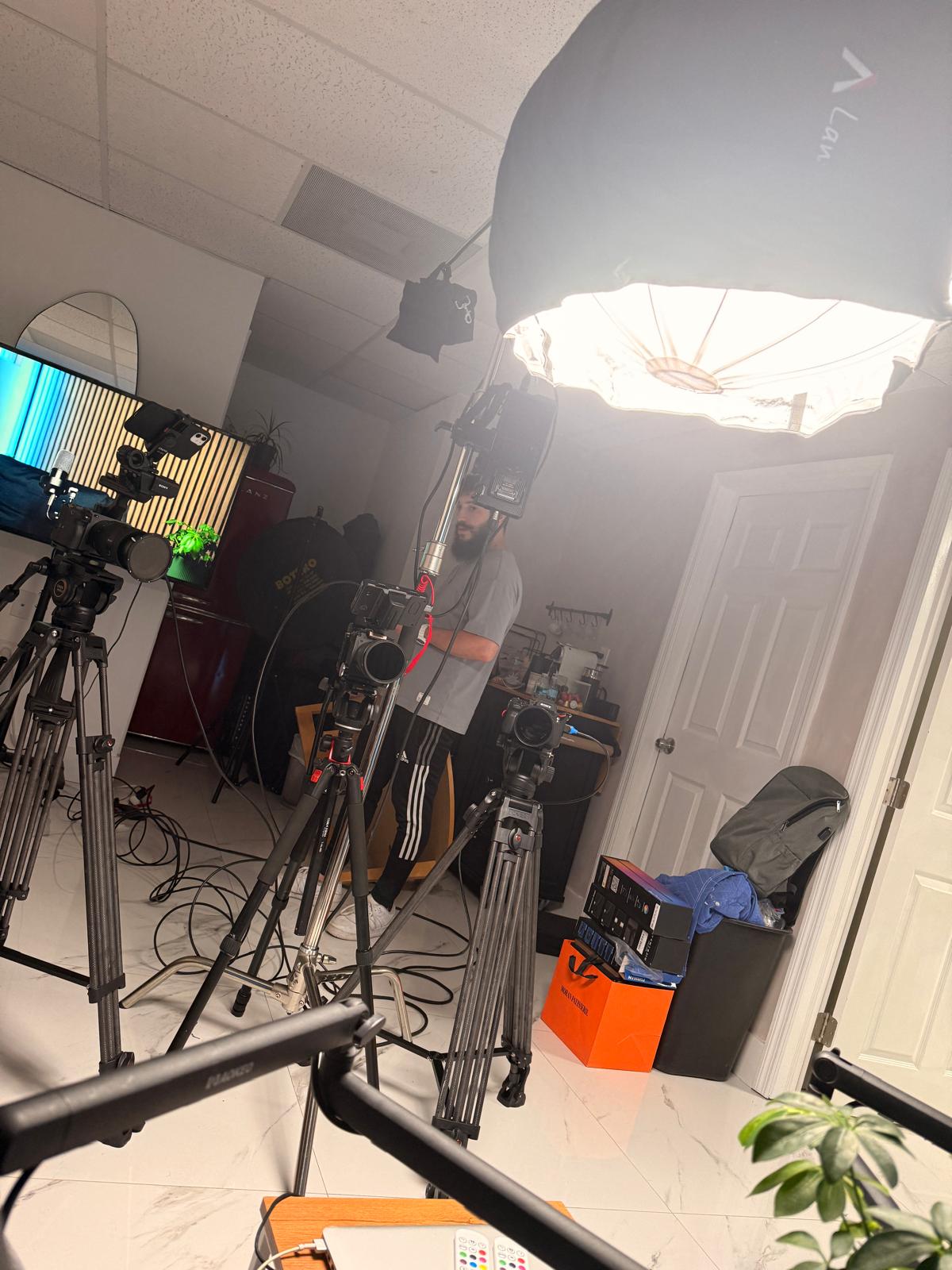 Softbox lighting and cameras on tripods set up in the podcast studio at Spark Studio