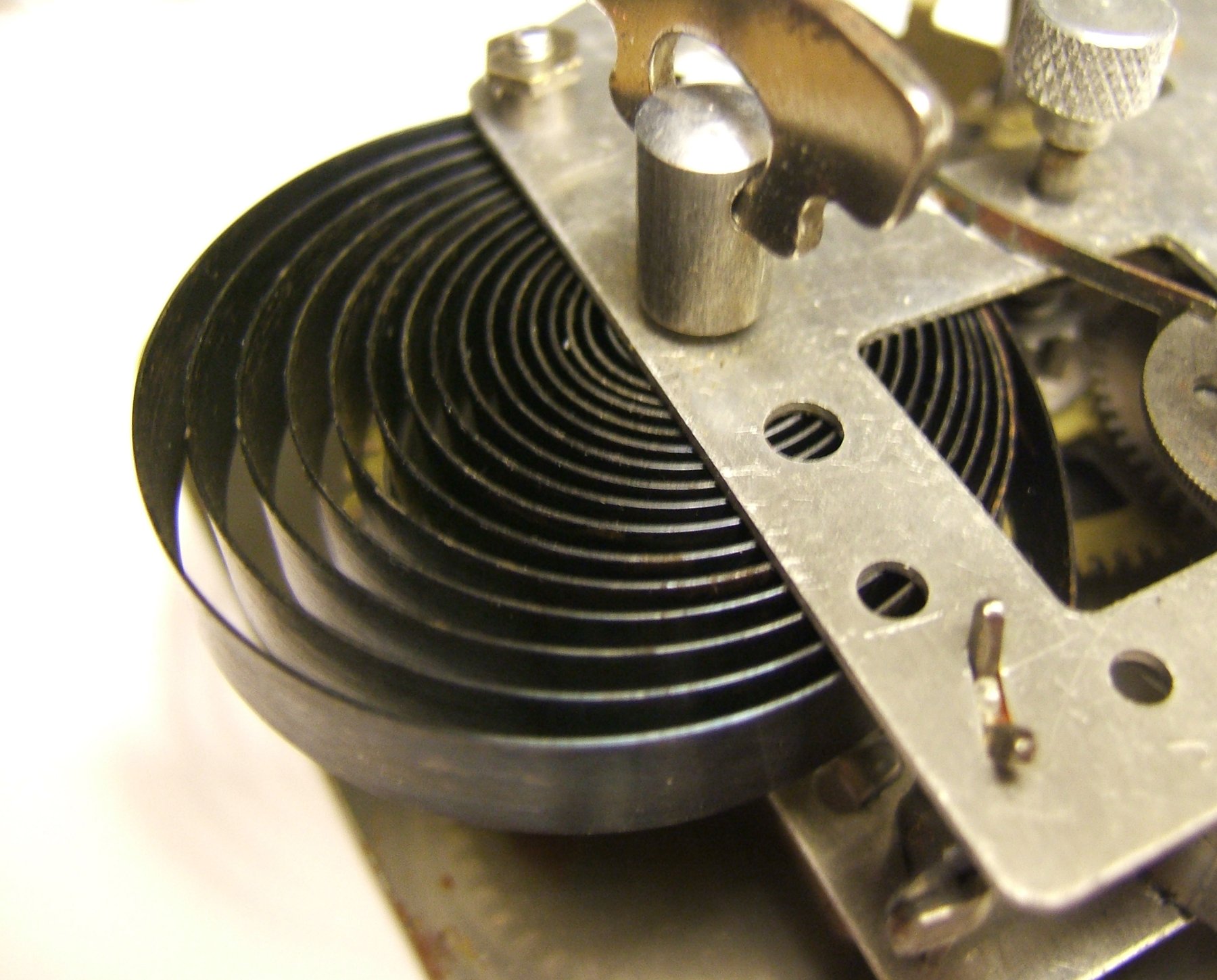 Vintage alarm clock standing on a plain surface