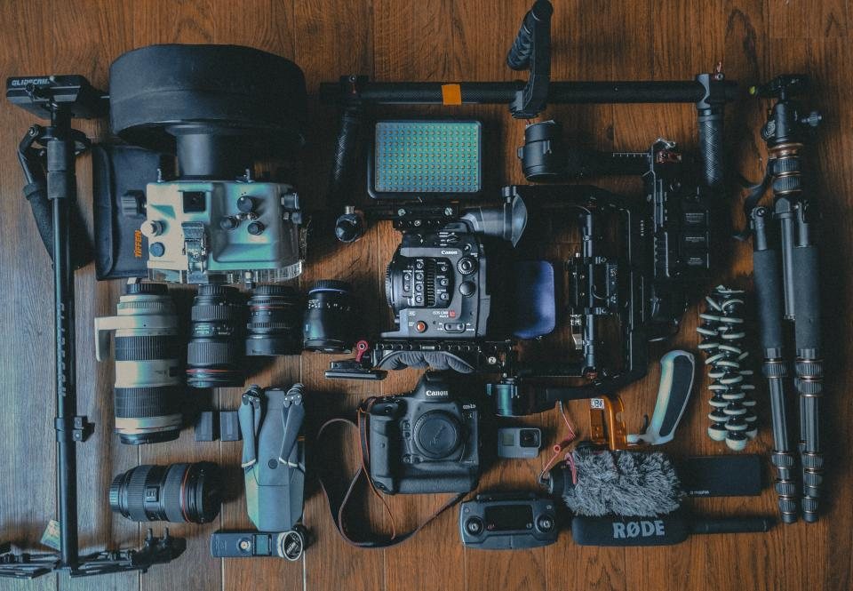 Camera bodies, lenses, microphones and rigging laid out in a case