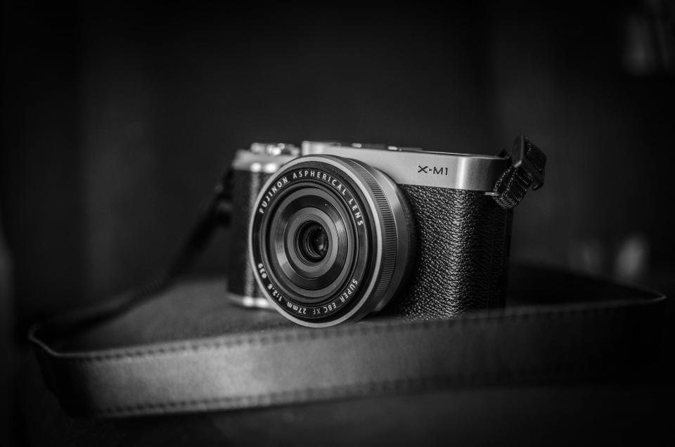 Mirrorless camera body and lens on a dark surface