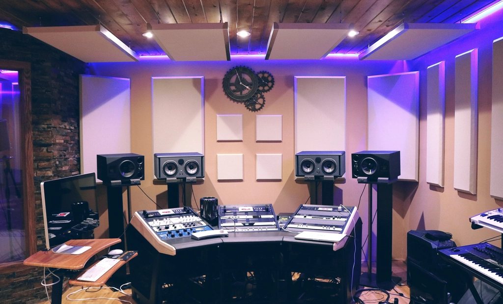 Recording room with acoustic panels and purple accent lighting