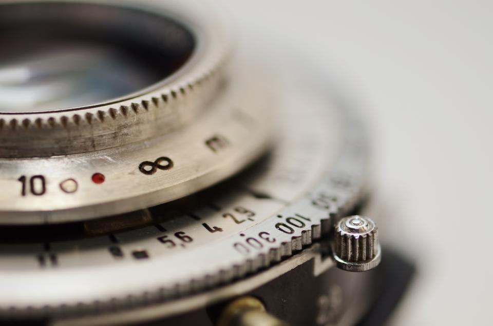 Close detail of a vintage camera lens focus ring
